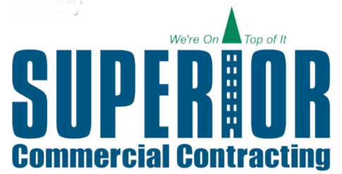Logo for Superior Commercial Contracting. The word SUPERIOR features a building design as the letter I, highlighting their expertise as a commercial roofer. Above, text reads We’re On Top of It with a green triangle as the building’s roof.