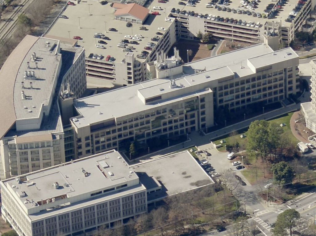 Aerial view of a multi-building office complex with an adjacent multi-level parking garage.